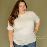 ivory unisex tshirt with sun on left chest ethically made by Sela Designs model wearing size extra large