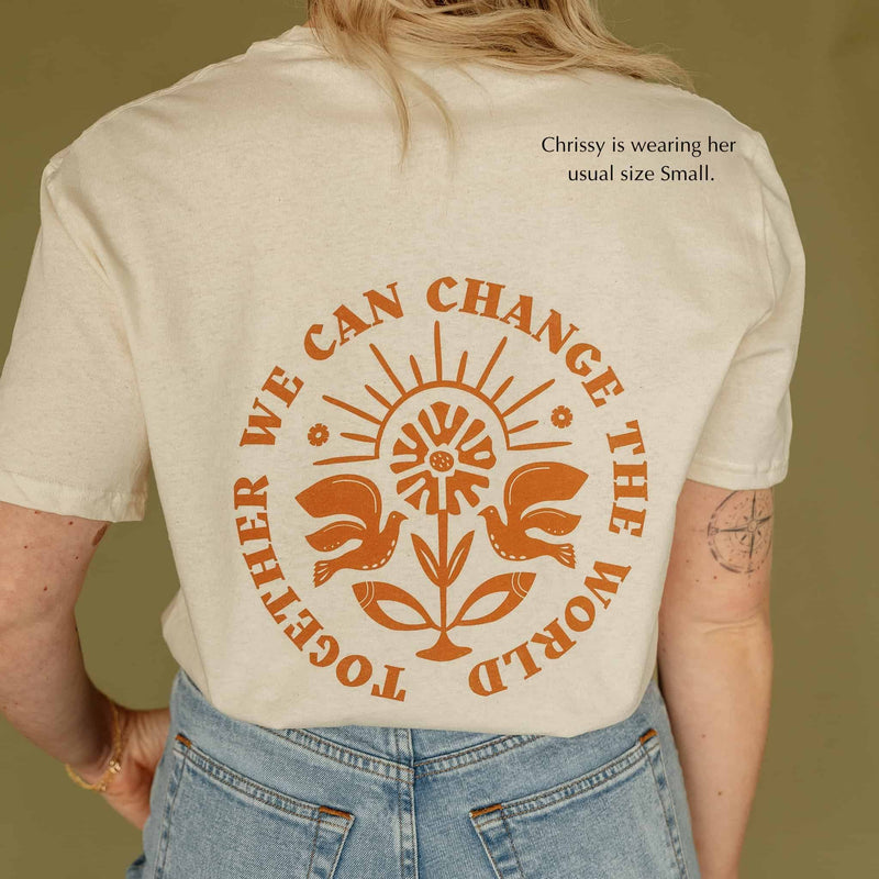 ivory unisex tshirt together we can change the world design on back made by Sela Designs